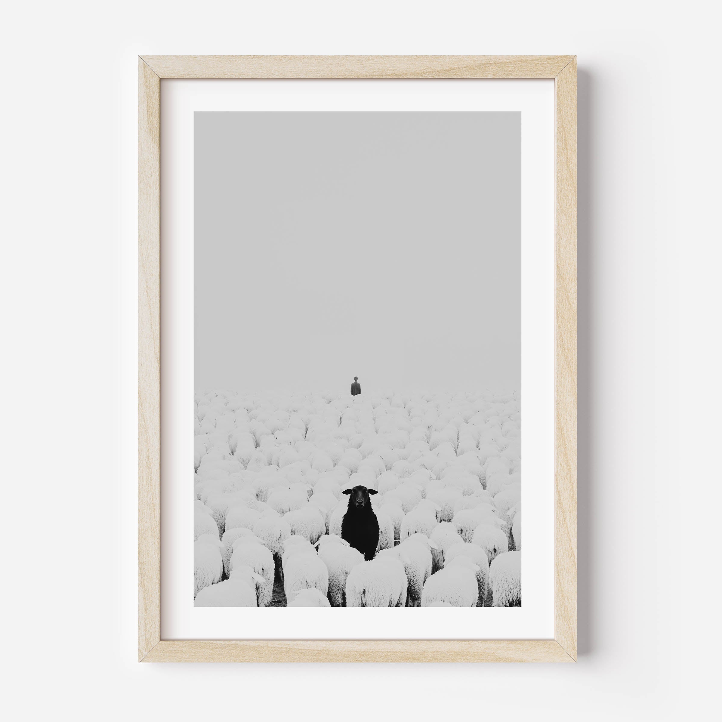 A motivational art print depicting a flock of sheep following a human, while one black sheep stands facing the opposite direction. Symbolizing individuality, courage, and breaking free from the crowd, this striking artwork serves as a reminder to think independently and stand out. Perfect for office or home décor.