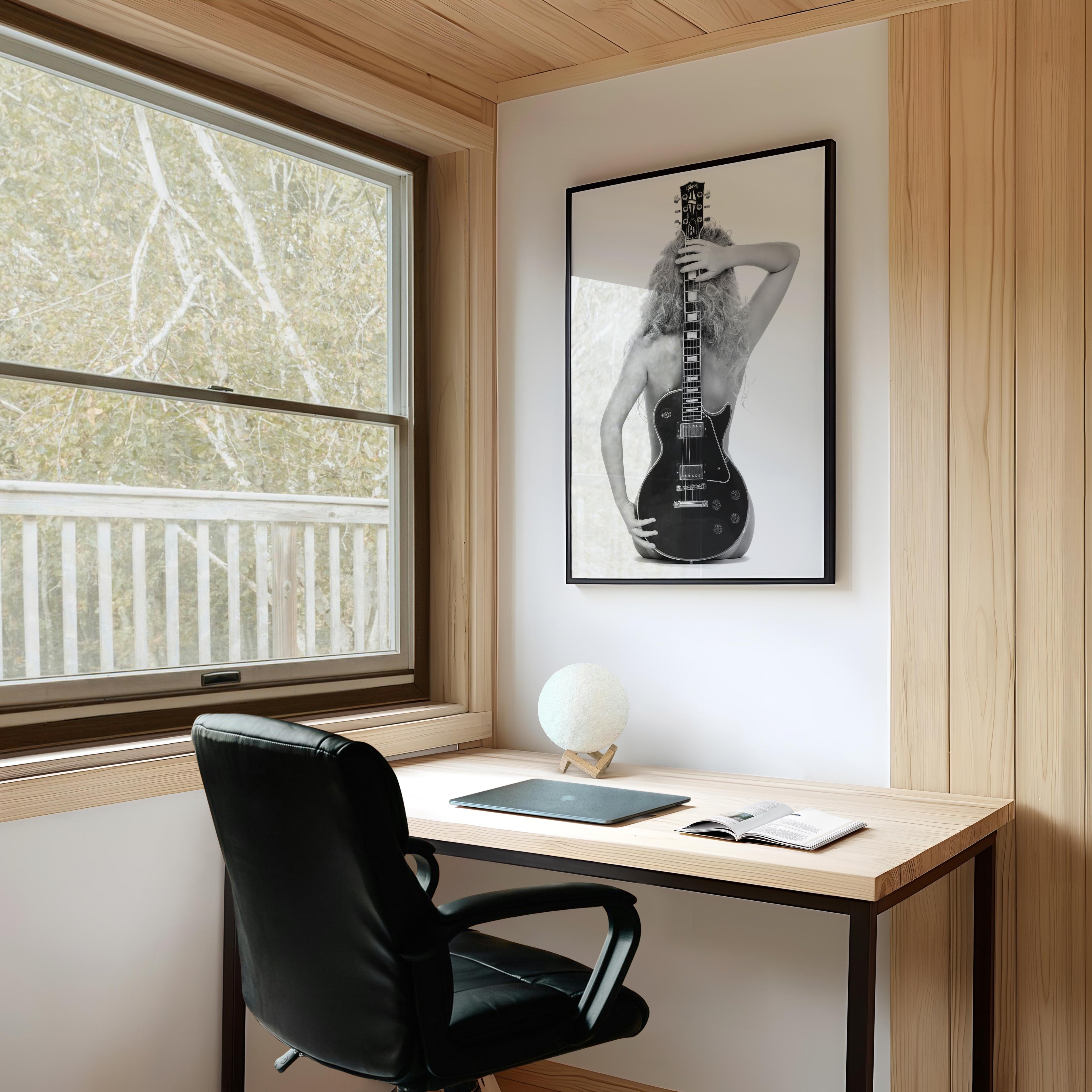 Black-and-white fine art print of a figure from behind holding an electric guitar on a white background.